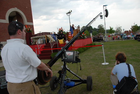 Willie George, PC support specialist, and Kyle Kurlick, junior photographer, capture spring graduation in various ways. - Photo by Morris Abernathy