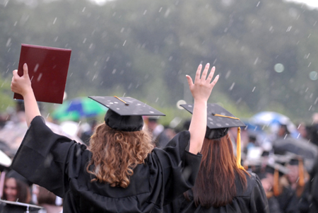 Kathleen Lokey (left), social work graduate, enjoyed the rain that fell during spring graduation. - Photo by Kathleen Murray