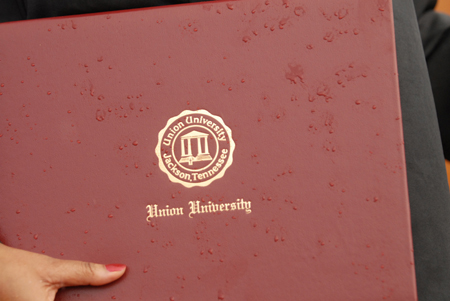 While the rain fell, Union continued to distribute diplomas during spring graduation on the Great Lawn. - Photo by Kathleen Murray