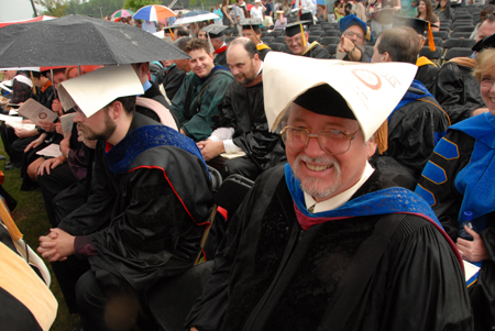 Terry Weaver, associate professor of special education, used his creativity to stay dry during the spring graduation ceremony on the Great Lawn. - Photo by Morris Abernathy