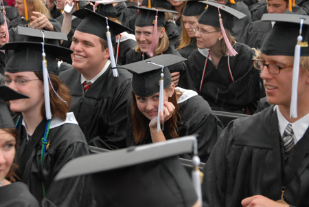 Spring graduates who had already been through the line honored the rest of the graduates by staying to the end in the rain. - Photo by Morris Abernathy