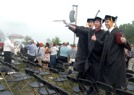 Tony Winkler, Luke Pruett and Brad Spencer pose for a photo after a rainy spring graduation. - Photo by Heather Phillips