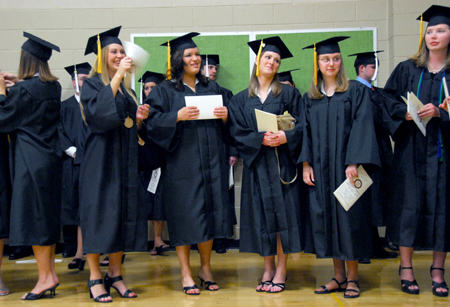 Katie Dratnol, Megan Donnelly, Tricia Currin, Stephanie Cooper, and Marci Coleman prepare for the processional to the Great Lawn for spring graduation. - Photo by Kyle Kurlick