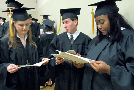 Holly Steele, Brad Spencer and Tasheena Richmond prepare for the processional to the Great Lawn for spring graduation. - Photo by Kyle Kurlick