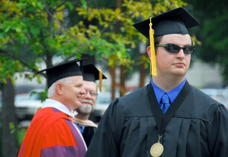Brent Michael Jones of Harrisburg, Ill. prepared for a sunny graduation ceremony. Unfortunately, heavy rain fell in the final minutes. Jones received a bachelor of science degree in chemistry and biology. - Photo by Kyle Kurlick