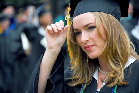 Michelle Pierce, public relations graduate, marches in the processional to the Great Lawn for the spring graduation ceremony. - Photo by Kyle Kurlick