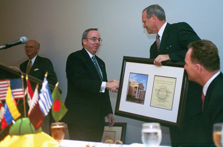 President David S. Dockery is presented with the 2002 Distinguished Alumni Award from Southwestern Baptist Theological Seminary at a dinner during the Southern Baptist Convention.  Presenting the award is Southwestern President Kenneth S. Hemphill. - Photo by Jim Veneman