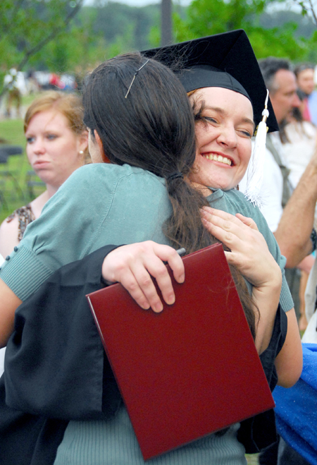 Cynthia Christine Keegan receives a big hug after the spring graduation ceremony. Keegan, from Murfreesboro, Tenn., received a bachelor of arts degree in art - Photo by Kyle Kurlick