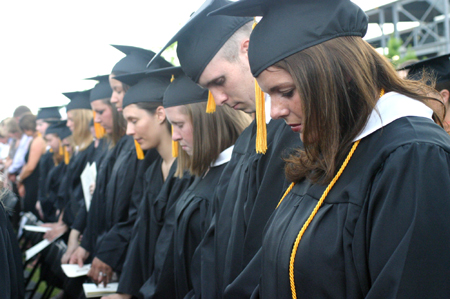 (right to left): Victoria Shackelford, Josh Webb, Kylie Sullivan, Danielle Spaulding and Tiffany Fisher Rhodes took a moment to reflect in prayer during the spring graduation ceremony. - Photo by Stephanie Schroeder