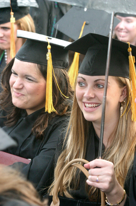 Katie Dratnol (right) of Ooltewah, Tenn. smiles after receiving a bachelor of science degree in special education. Dratnol won special education teacher of the year award and a medal for academic excellence. Megan Colleen Donnelly (left) of Edmond, Okla., received a bachelor of science degree in learning foundations. - Photo by Stephanie Schroeder