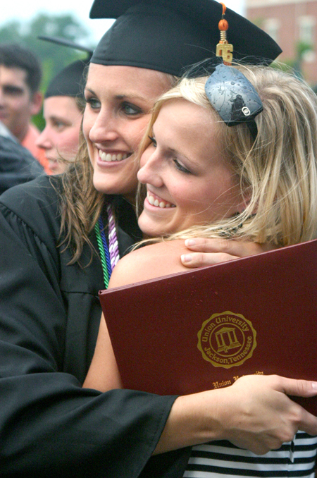 Kari Elizabeth Bachman (left) of Louisville, Ky., accepts congratulations from Ashley Cherry, a junior Christian Studies major. Bachman received a bachelor of science degree in nursing. - Photo by Stephanie Schroeder
