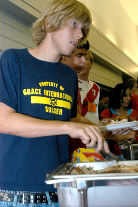Freshman Daniel Palmer of New Johnsonville,
Tenn. enjoys some picnic fare during New Student Orientation. - Photo by Heather Phillips