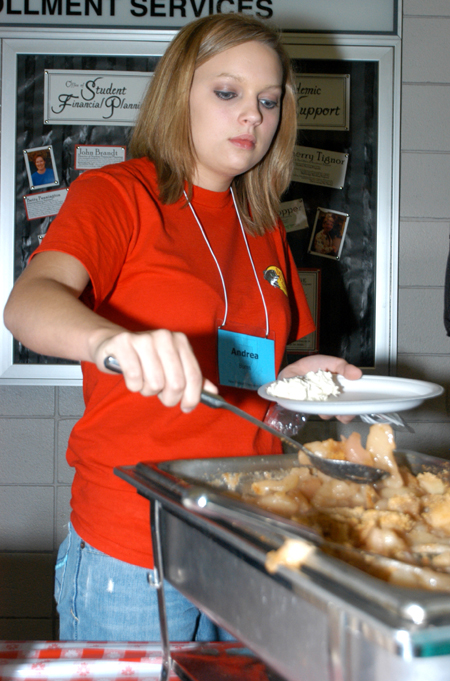 Freshman Andrea Burns of Ramer, Tenn. enjoys some apple cobbler during New Student Orientation. - Photo by Heather Phillips