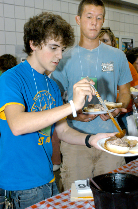 Matt Elia and Daniel Cathey grab some barbeque during New Student Orientation.  - Photo by Heather Phillips