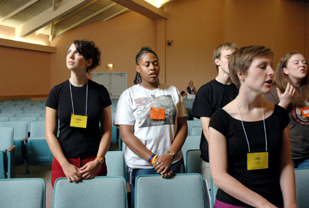 Freshman Lydia Livingston looks skyward as Renee Hayes and Jill Zimmer sing during worship at New Student Orientation. - Photo by Kristen Nicole Sayres