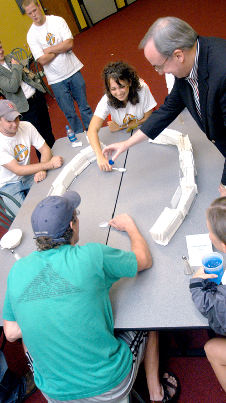 President Dockery officiates an intense game of spoon hockey between Lydia Livingston & Douglas Martin during the Ice Cream Social at New Student Orientation. - Photo by Brad Moore