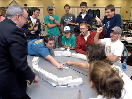 The crowd goes wild as they watch the intense game of spoon hockey between Cassie Harris & Lydia Livingston during the Ice Cream Social at New Student Orientation. - Photo by Brad Moore