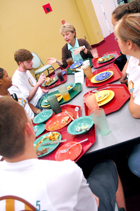 Sherry Tignor, co-director of the center for new students, talks with students during a New Student Orientation dinner. - Photo by Kristen Nicole Sayres