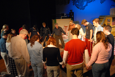 David Burke and the cast of <em>The Spitfire Grill</em> pray after a rehearsal. - Photo by Morris Abernathy