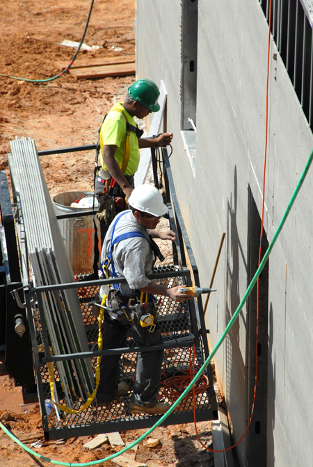 The outer walls of White Hall began to go up during June. - Photo by Morris Abernathy