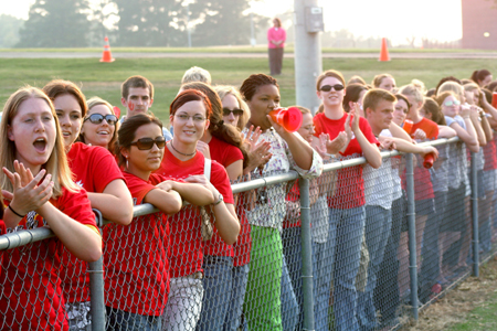 Bulldog fans line the fence at a men's soccer match. - Photo by Kyle Kurlick