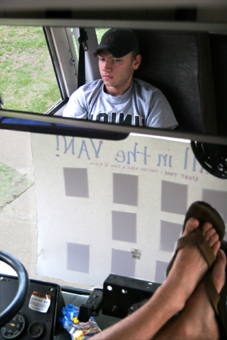 Tyler Boykin relaxes in the driver's seat of the bus during the annual Roadtrip to Nowhere sponsored by Young Alums, before it was cut short due to  inclement weather.  - Photo by Kyle Kurlick