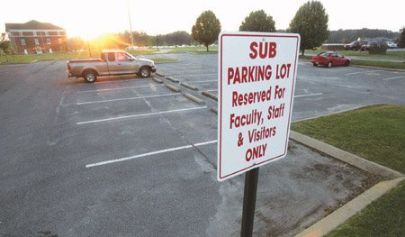A single vehicle stands in one of the many parking lots with new restrictions. Parking restrictions were implemented in the Fall of 2002. - Photo by Justin Veneman
