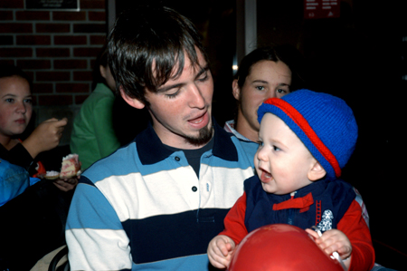 Andy Robinette enjoys his time together with a younger family member at a dessert during Family Weekend. - Photo by Brad Moore