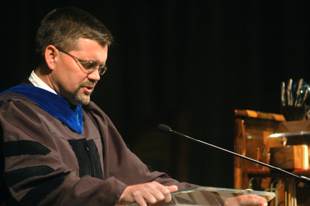 Chris Hail, professor of mathematics, leads in prayer during the Awards Day chapel. - Photo by Kyle Kurlick