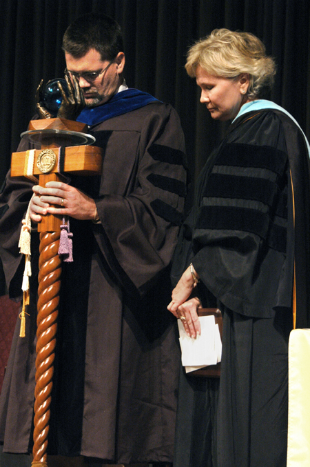 Chris Hail and Pam Sutton, faculty members of the year 2004-2005 and 2005-2006 respectively, bow in prayer at the conclusion of the Awards Day ceremony. - Photo by Kyle Kurlick