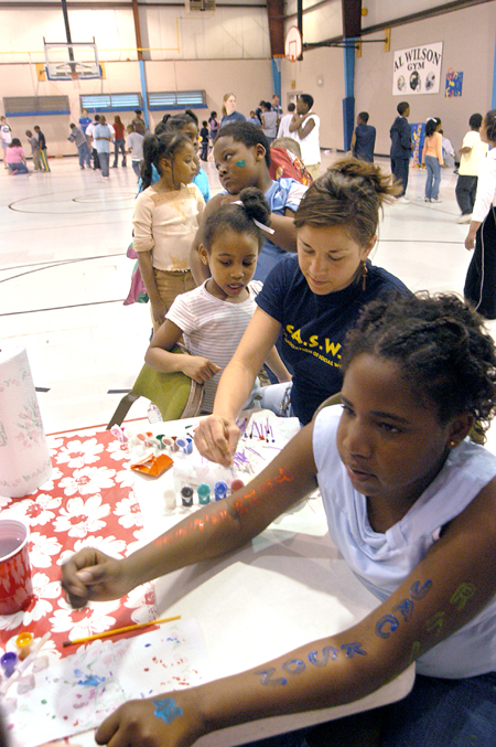 Gina Orosz mans a body painting station at the Jackson Boys & Girls Club during The Spring Fling. The Spring Fling was an activity where the Club and SASW collaborated to make a day of excitement for at-risk kids while giving student social workers experience. - Photo by Heather Phillips