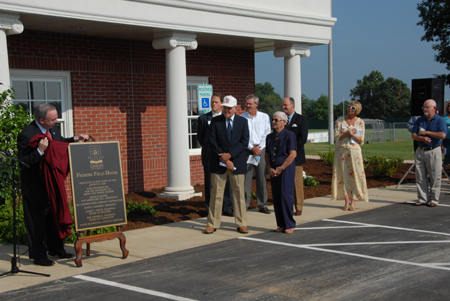President David S. Dockery unveils the plaque that will be placed on the wall at the Fesmire Field House. - Photo by Morris Abernathy