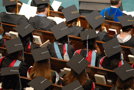 Graduates anticipate the delivery of their diplomas during summer graduation. - Photo by Morris Abernathy