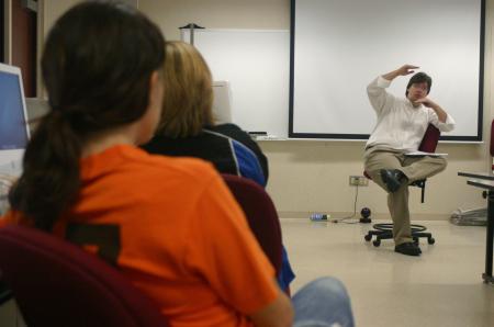Chris Blair, acting chair and associate professor of communication arts, motivates the Cardinal & Cream staff to keep up the good work and to keep their eyes open for new ideas. - Photo by Stephanie Schroeder