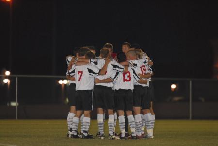 Just before their game against Lindsey Wilson College, the men's soccer team huddles up. - Photo by Morris Abernathy