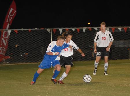 Freshman Paul Turner fights for position against a Lindsey Wilson player as Junior Benny Crozier looks on. - Photo by Morris Abernathy