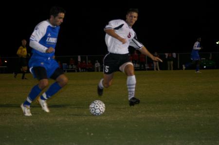 Junior Scott Sinclair drives the ball upfield against a Lindsey Wilson opponent. - Photo by Stephanie Schroeder