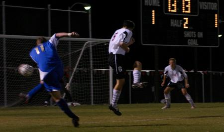 Senior Duncan Nicol braces himself as a Lindsey Wilson opponent makes a shot on goal as Junior Colin Bonner looks on. - Photo by Stephanie Schroeder