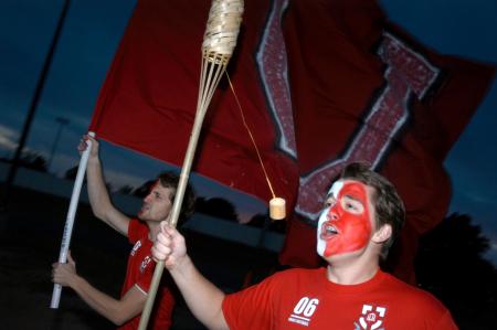 Ronald Long and Jonathan Lambach lead the charge of students as they dash onto the soccer field to support the men's soccer team before their game against Lindsey Wilson College. - Photo by Kyle Kurlick