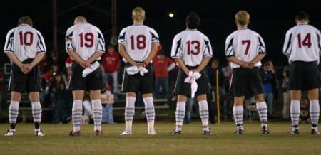 The men's soccer team stand at attention during the national anthem at their game against Lindsey Wilson College. - Photo by Kyle Kurlick