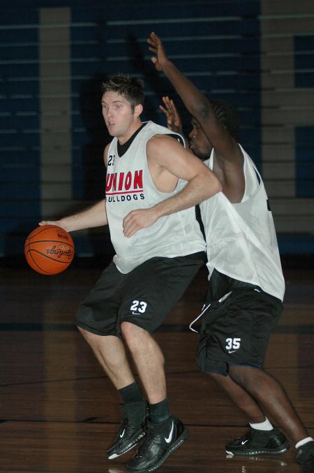 Junior Ryan Merriman and Freshman Kennedy Okello battle during practice in preparation for thie season-opener versus Olivet Nazarene. - Photo by Holly Gushee