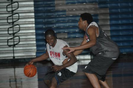Freshman Kennedy Okello drives against senior forward Dewayne Lee during a Bulldog practice session. - Photo by Holly Gushee