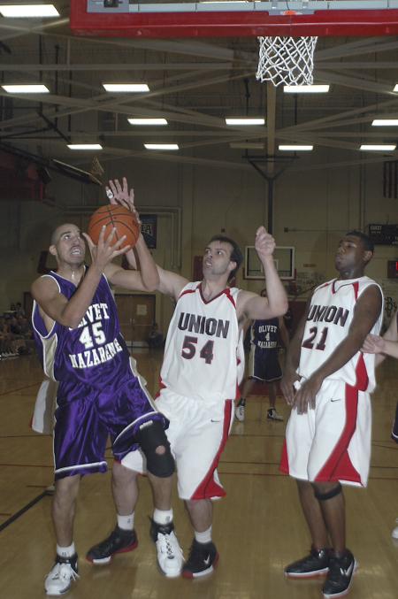 Senior Ben Frederick and Sophomore Brian Lake defend against an Olivet Nazarene player during the Homecoming game.  - Photo by Holly Gushee