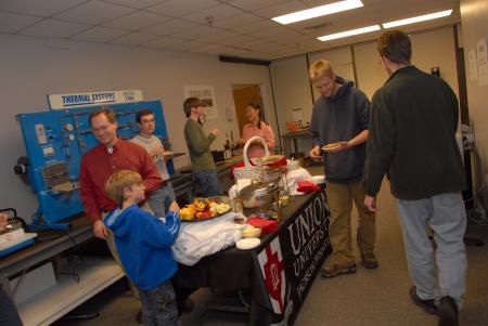 Engineering students and alum gather for a reception in the engineering lab during Homecoming. - Photo by Morris Abernathy