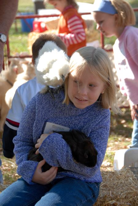 A future Unionite interacts with some small animals at the Arts in the Park event during Homecoming. - Photo by Morris Abernathy