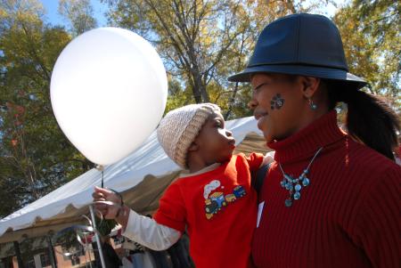 Alum and Union Staffer Renee Jones and her son David enjoy spending some time together at the Arts in the Park event during Homecoming. - Photo by Morris Abernathy