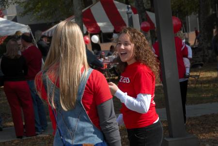 Senior Katie Daniel (right) fellowships with fellow Senior Andrea Sarine at the Arts in the Park event during Homecoming. - Photo by Morris Abernathy