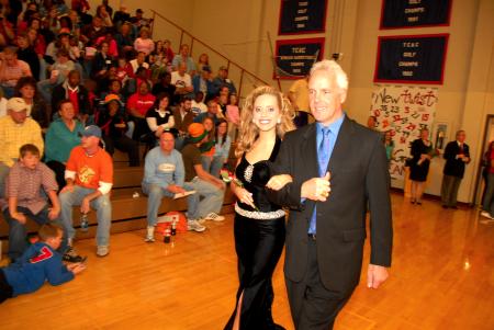 Freshman Elizabeth Wood, public relations and advertising major from Crossville, Tenn., who is the daughter of Michael and Debbie Wood, is escorted by her father onto the court before the naming of the queen during Homecoming. - Photo by Morris Abernathy