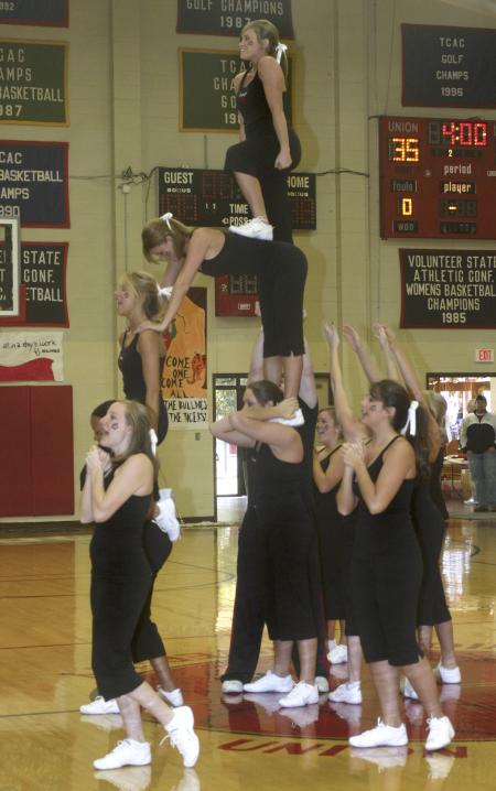 The Union Cheerleaders perform a stunt during half time of the women's basketball Homecoming game against  St. Gregory's University, Okla. - Photo by Stephanie Schroeder