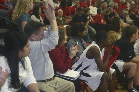 Honorary Coach Gary Williams cheers from the bench with the coaches and players during the Homecoming game against St. Gregory's University, Okla. - Photo by Stephanie Schroeder